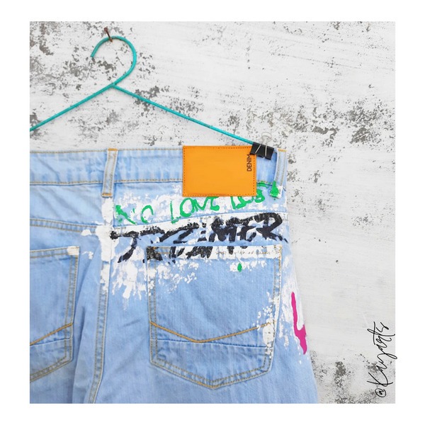 Rear denim pocket with colorful hand-painted street art design