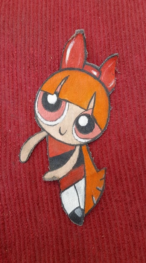 hand painted clothing of Blossom from the Powerpuff Girls on a red background