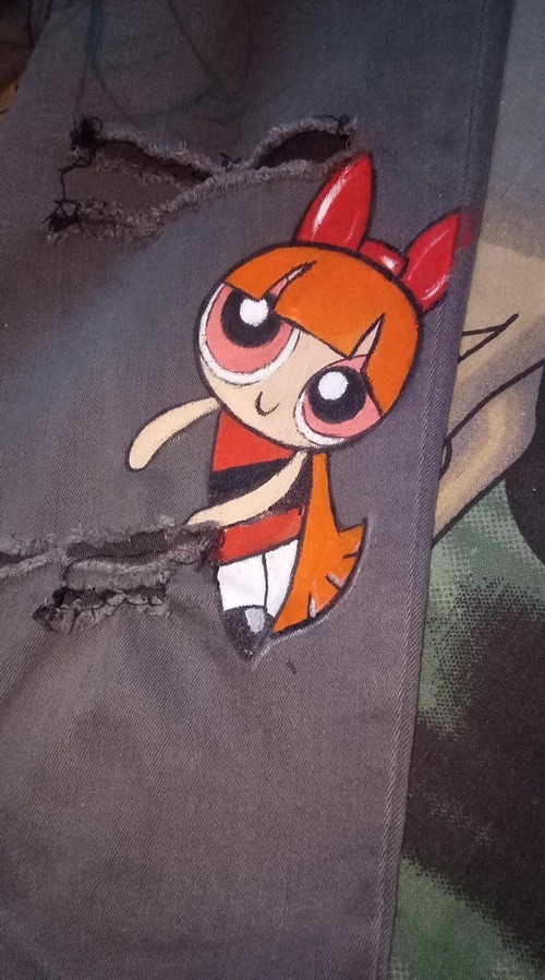 Close-up of Blossom character hand-painted on black jeans fabric
