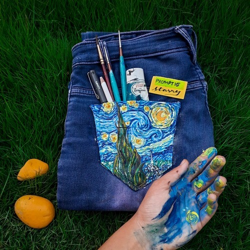 Denim-themed starry artwork with celestial stickers and paint