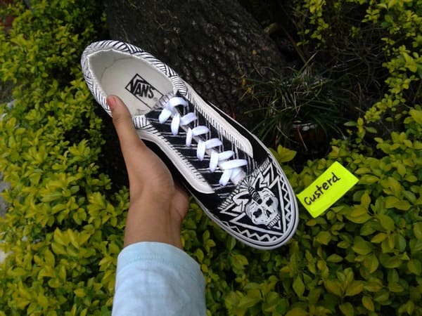 Vans black and white skull custom sneakers close outdoor