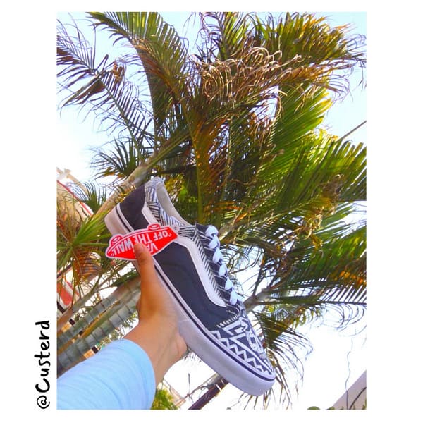 Vans black and white skull custom sneakers hand held outdoor